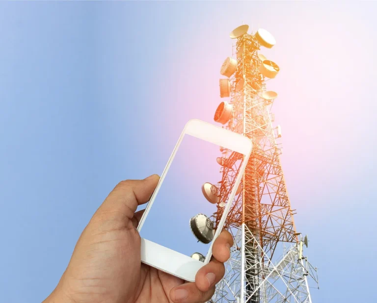 Hand,holding,the,smartphone,on,telecommunication,radio,antenna,background,with